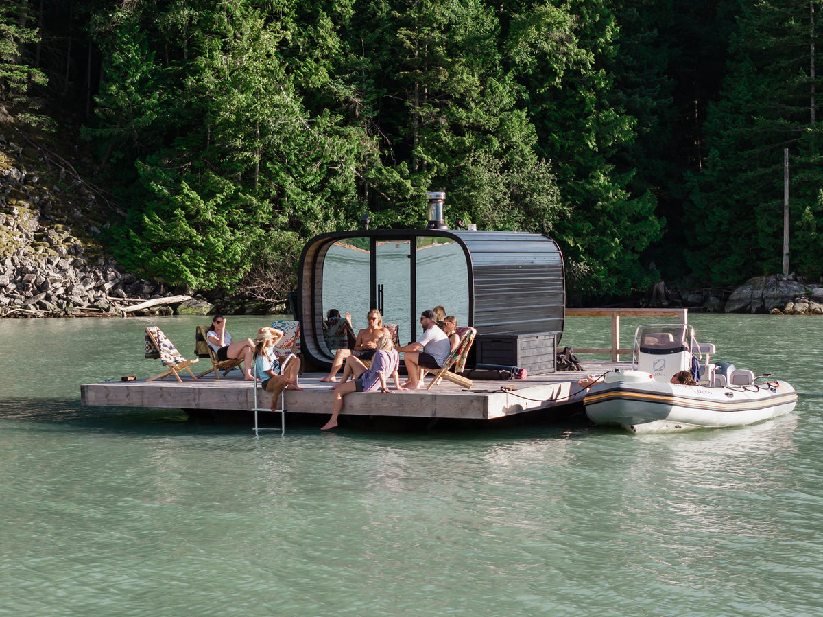 Friends relaxing beside the floating sauna on Howe Sound