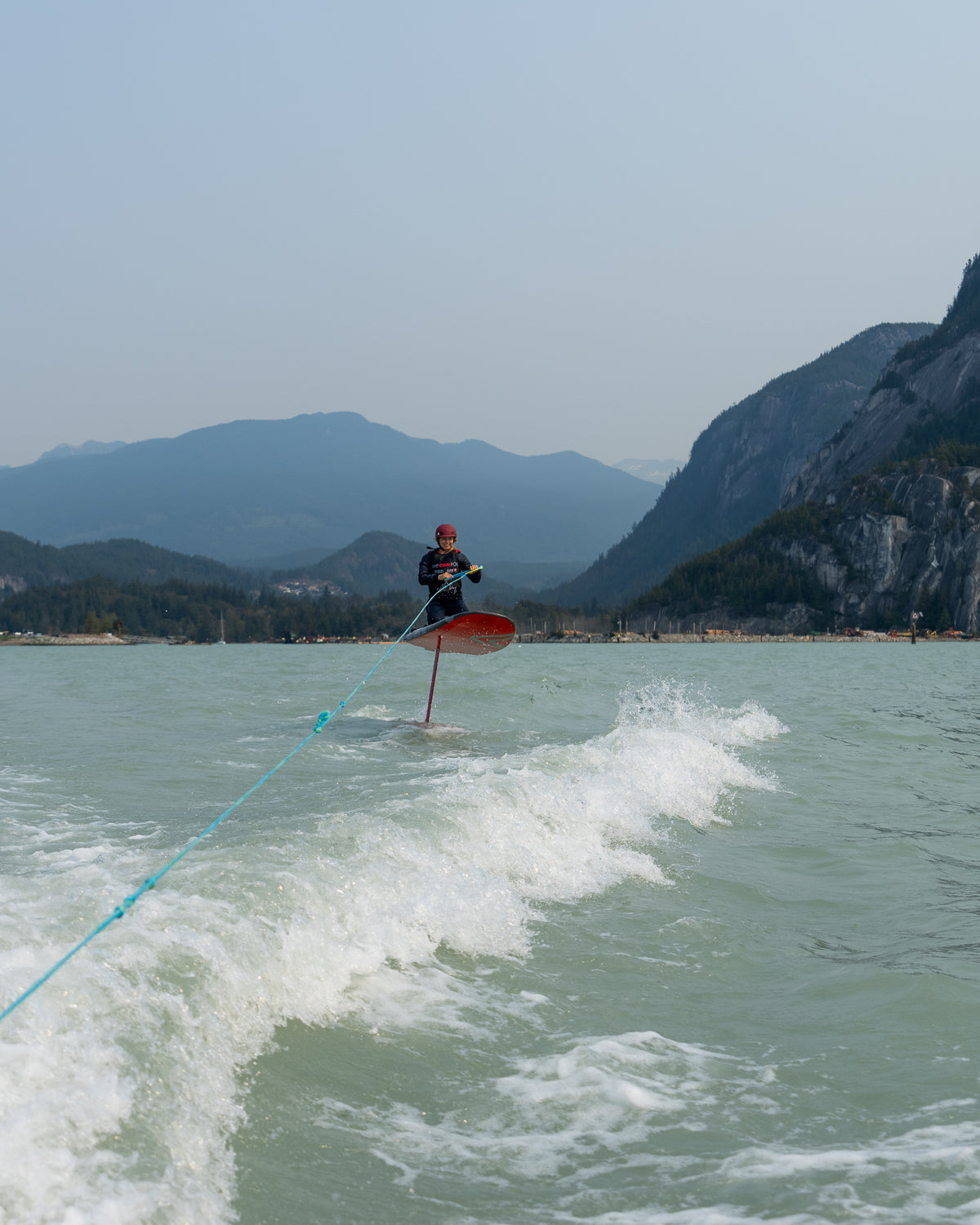 Wing foiling beneath the mountains in Squamish, BC