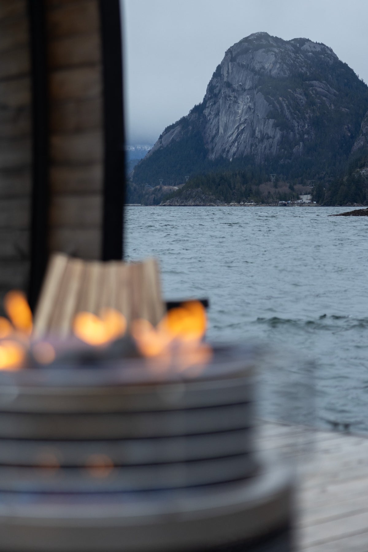 Winter mountain views across Howe Sound from beside the floating sauna fire