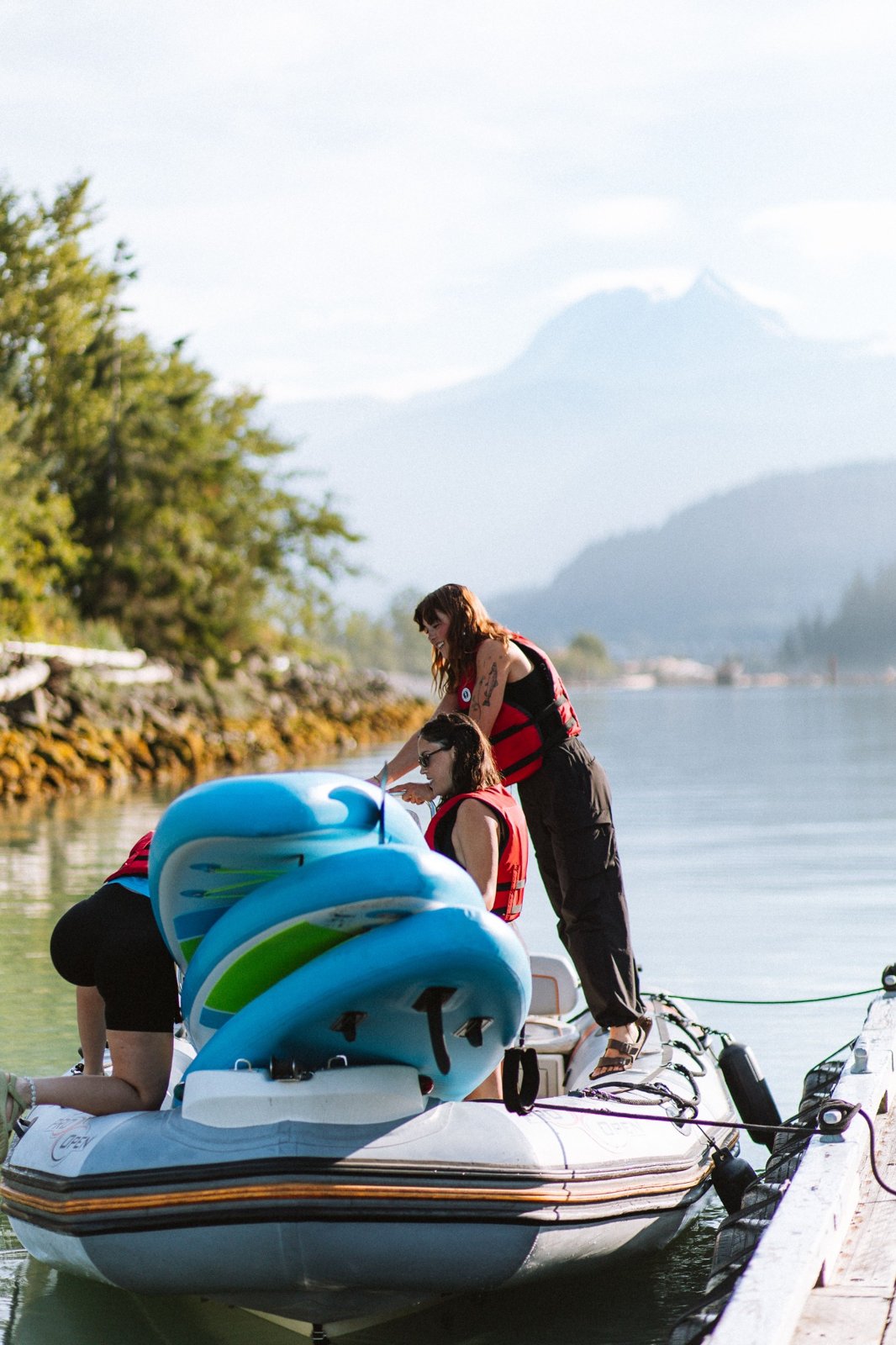 Paddleboards being prepared beside the water